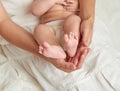 Baby legs in mother hands on white Royalty Free Stock Photo