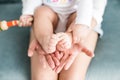 Baby legs in mother hands on white background Royalty Free Stock Photo
