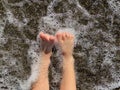 Baby legs in sea wave splashes