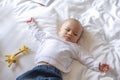 The baby lie leisurely and lull with parents in the living room at house.