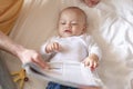 The baby lie leisurely and lull with parents in the living room at house. Royalty Free Stock Photo