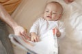 The baby lie leisurely and lull with parents in the living room at house. Royalty Free Stock Photo