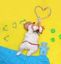 Baby lies and holds a big heart in his hands, love Royalty Free Stock Photo