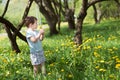 Baby little boy holds dandelion, sunny day. Summer Meadow