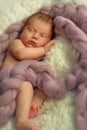 Baby little girl sweetly sleeps covered with fluffy yarn. Royalty Free Stock Photo