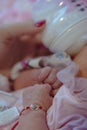 Baby little hands, soft selective focus. Mom feeds baby with a bottle of milk. Lovely family memories. Royalty Free Stock Photo