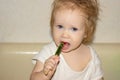 The baby and a lollipop in the form of a triangular piece of watermelon