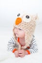 Baby Looking to the Side in Owl Hat Royalty Free Stock Photo