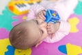 Baby lying on child friendly floor puzzle Royalty Free Stock Photo