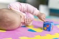 Baby lying on child friendly floor puzzle Royalty Free Stock Photo