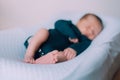 The baby is lying in a cocoon of copy space . The baby is 0-3 months old. A contented infant. An article about choosing Royalty Free Stock Photo