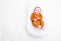 The baby is lying in a cocoon of copy space . The baby is 0-3 months old. A contented infant. An article about choosing Royalty Free Stock Photo