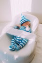 The baby is lying in a cocoon of copy space . The baby is 0-3 months old. A contented infant. An article about choosing Royalty Free Stock Photo