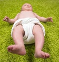 Baby Lying on Green Carpet