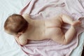 Baby is lying on a pink towel view from above Royalty Free Stock Photo