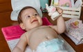 Baby lying playing with a rubber toy Royalty Free Stock Photo