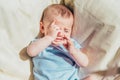 Baby lying in the sun angry and crying calling his parents Royalty Free Stock Photo