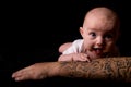 Baby Lying on Tattooed Arm