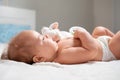 A baby is lying with a toy in the cradle. Close-up. The concept of parenthood Royalty Free Stock Photo