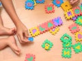 Baby making puzzle. Child jigsaw develops children. Kid holding