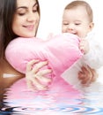 Baby and mama with heart-shaped pillow