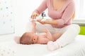 Baby massage background. Kids therapist applying massage oil to baby boy. Mother massaging her newborn baby. Royalty Free Stock Photo