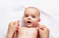 Baby massage. Gymnastics for small kids. Top-view. Royalty Free Stock Photo
