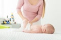 Baby massage. Kids therapist applying massage oil to baby boy. Mother massaging her newborn baby. Royalty Free Stock Photo