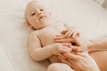 Baby massage, Mom massages the baby`s belly during colic Royalty Free Stock Photo