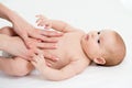 Baby massage. Mom massaging child belly. Treatment of colic Royalty Free Stock Photo