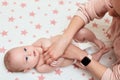 Baby massage. Mother massaging her newborn baby. Royalty Free Stock Photo