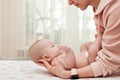 Baby massage. Mother massaging her newborn baby. Royalty Free Stock Photo