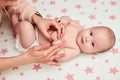 Baby massage. Mother massaging her newborn baby. Royalty Free Stock Photo