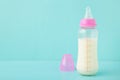 Baby milk bottle on blue background with copy space Royalty Free Stock Photo