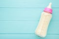 Baby milk bottle on blue wooden background Royalty Free Stock Photo