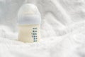 Baby milk formula in small bottle on white fluffy background Royalty Free Stock Photo