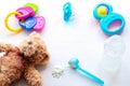 Baby milk powder, baby bottle and children`s toys on a light background flat lay Royalty Free Stock Photo