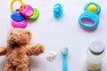 Baby milk powder, baby bottle and children`s toys on a light background flat lay Royalty Free Stock Photo