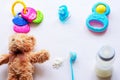 Baby milk powder, baby bottle and children`s toys on a light background flat lay Royalty Free Stock Photo