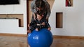 Mom is doing exercises for the baby. Baby and mom develop body motility