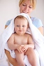 Baby, mom and hug for bath with care in a closeup for clean kid at home with love and caring. Towel, mother and infant