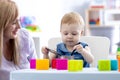 Baby with mom play in nursery Royalty Free Stock Photo