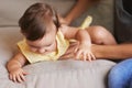 Baby, mom and playing on couch, child development and infant growth with happy, coordination and home. Girl, learning Royalty Free Stock Photo