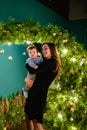 Baby with mother at Christmas. happy family mother and baby little son playing home on Christmas holidays. New Year`s holidays. Royalty Free Stock Photo