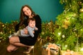 Baby with mother at Christmas. happy family mother and baby little son playing home on Christmas holidays. New Year`s holidays. Royalty Free Stock Photo