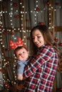 Baby with mother at Christmas. happy family mother and baby little son playing home on Christmas holidays. New Year`s holidays. Royalty Free Stock Photo