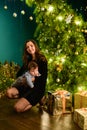 Baby with mother at Christmas. happy family mother and baby little son playing home on Christmas holidays. New Year`s holidays. Royalty Free Stock Photo