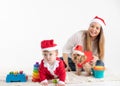 Baby, mother and dog disguised as santa claus