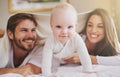 Baby, mother and father playing with blanket in bedroom for love, care and quality time together. Portrait of cute Royalty Free Stock Photo