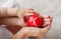 Baby and mother holding red heart with ecg line Royalty Free Stock Photo